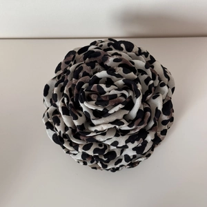 Detailed view of handmade rose hair claw with elegant leopard print fabric texture