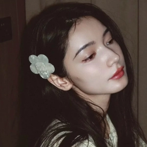 Elegant floral acetate hair clip in pale jade green worn by model in vintage style