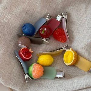 Cute fruit hair clips featuring resin blueberry and strawberry designs on acetate slides