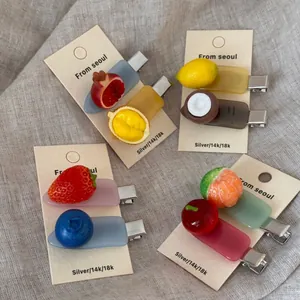 Close-up of cute fruit acetate hair clips including lemon and strawberry on display card