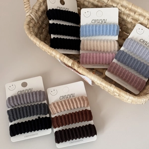 Set of 3 high-elasticity wide ribbed hair ties in assorted neutral colors on display