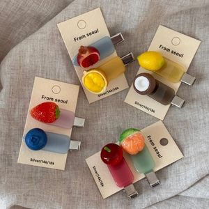 Set of cute acetate fruit hair clips including strawberry, lemon, and cherry on card