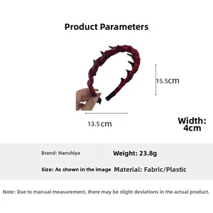 Detail of red and black plaid fabric headband showing inner plastic teeth and dimensions