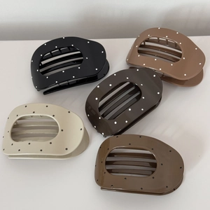Oval polka dot claw clips in five earth tones featuring a vintage glossy finish