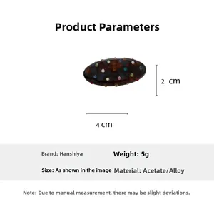 Detail view of oval tortoise acetate hair clip with colorful rhinestones and alloy base
