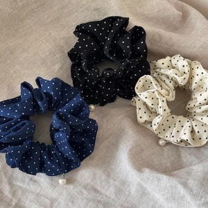 Three-piece French polka dot scrunchies set in navy, black, and beige with pearl charms