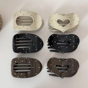 Flat oval and heart hair claw clips with polka dots in beige, black, and brown