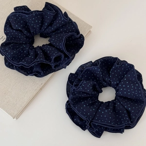 Set of two navy blue polka dot fabric scrunchies with stylish pleated texture