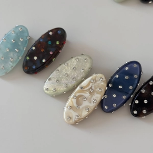 Oval rhinestone duckbill hair clips in assorted colors and shimmering resin textures