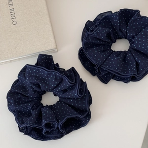 Dark blue navy polka dot fabric scrunchie with ruffled texture and large size design