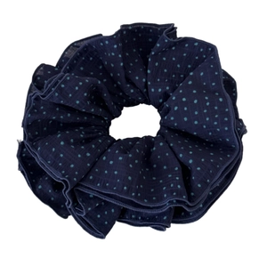 Dark blue fabric scrunchie with light blue polka dots and soft pleated texture