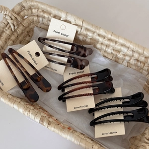 Close-up of stylish leopard and tortoiseshell hair clips set on a display card
