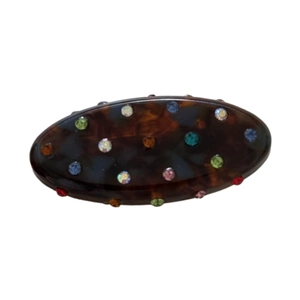 Elegant oval tortoiseshell hair clip with colorful rhinestones on a white background