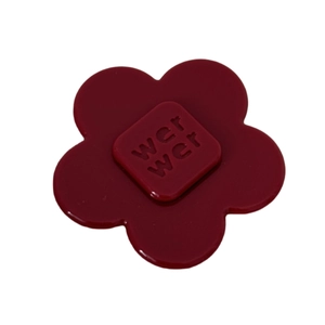 Elegant deep red acetate flower hair clip with embossed letter detail on white background