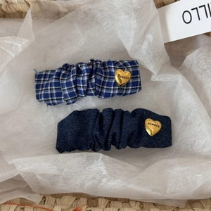 Blue plaid and denim hair clip set with golden heart pendants on white paper