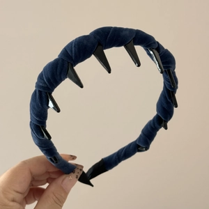 Close-up of navy blue velvet braided headband featuring internal black hair comb teeth