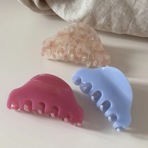 Trois pinces à cheveux demi-cercle en acétate rose, bleu et marbré sur tissu en lin