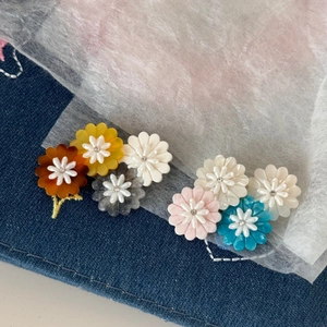 Floral acetate daisy hair clips in vibrant colors with sparkling rhinestone centers