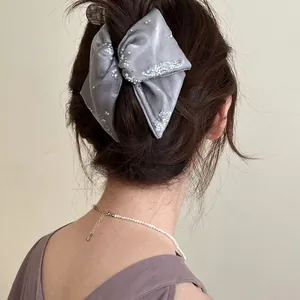 Elegant grey satin oversized bow hair clip with sparkling silver sequins for women