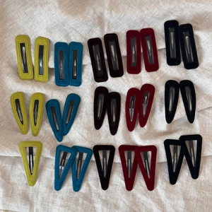 Close-up of assorted velvet hair clips in teardrop and triangle shapes and rich colors