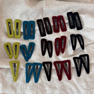 Detailed view of velvet BB hair clips in geometric shapes and rich autumn colors
