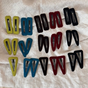 Detailed view of assorted velvet BB hair clips in geometric shapes on linen background