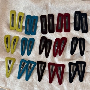 Macro view of vintage velvet geometric hair clips set in diverse colors and shapes