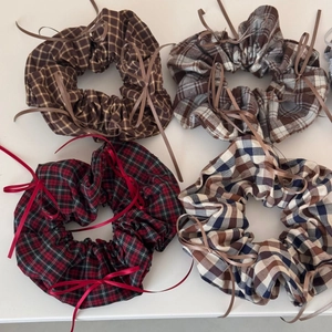 Set of four plaid scrunchies with delicate ribbon bows in classic checkered patterns