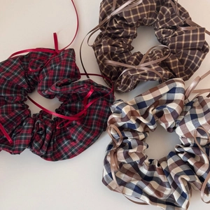 Three-piece set of plaid scrunchies with ribbon bows in red, brown, and beige patterns