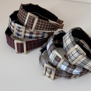 Detailed close-up of retro plaid fabric headbands featuring decorative resin buckles