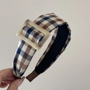 Detail view of vintage brown plaid wide headband with white square resin buckle