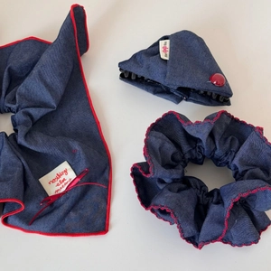 Detail of three-piece navy denim hair accessories with red lace trim and fabric labels
