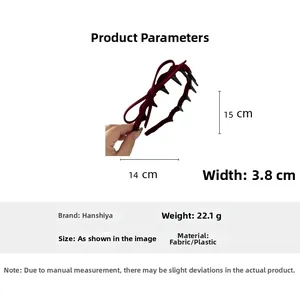 Detail view of burgundy velvet bow headband with inner comb teeth and size measurements
