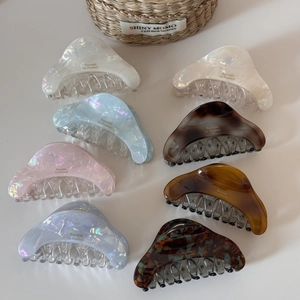 Detail view of colorful acetate hair claw clips set with elegant pearlescent finish