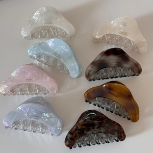 Flat lay of colorful acetate hair claws in various marble patterns for thick hair styling