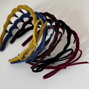 Detail view of velvet bow headbands set showing soft fabric texture and inner teeth