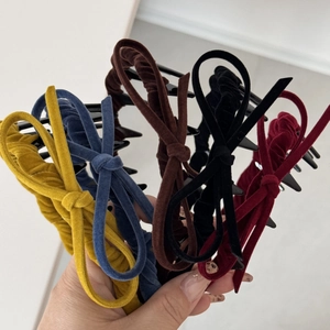 Detail view of colorful velvet bow headbands featuring soft texture and retro design