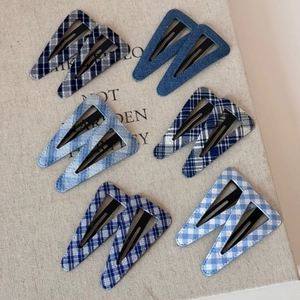 Blue denim and plaid pattern triangle BB hair clips set with twelve pieces on fabric