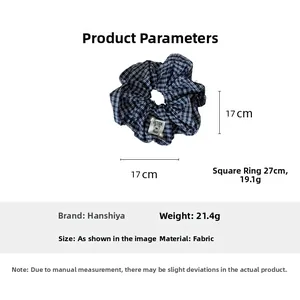 Detail showing the 17cm large dark plaid scrunchie with bear patch and pearl detail