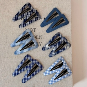 Detailed set of 12 triangular snap clips with diverse blue denim and plaid fabric patterns
