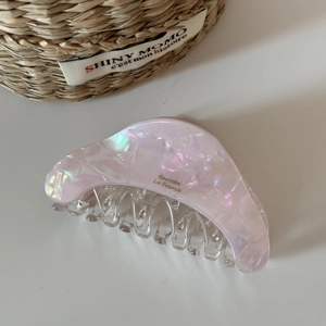 Detailed macro of pink iridescent acetate hair claw with gold Barrette La France lettering