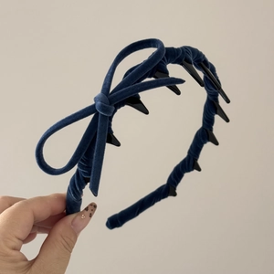 Close-up of navy velvet headband with bow knot and anti-slip teeth detail