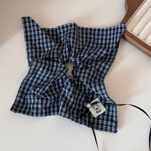 Detail of checkered scrunchie with fashion bear tag, pearl accent and black ribbon