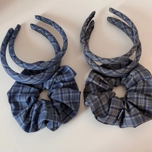 Close-up of blue plaid fabric hair set with two headbands and a scrunchie detail