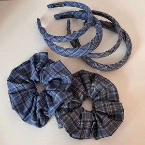 Detail of blue plaid fabric headband and scrunchies set with a classic checkered pattern
