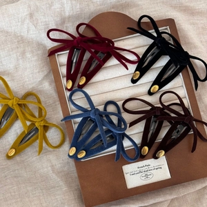 Set of five elegant velvet bow hair clips in assorted vintage colors with gold tag details