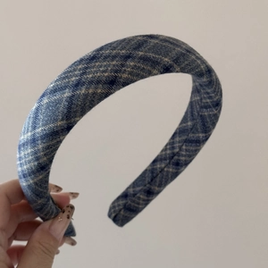 Detailed view of the navy blue and cream plaid fabric headband with thick padded design