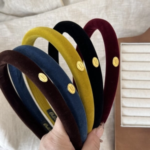 Velvet padded headbands in five colors with oval gold metal smile charms for women