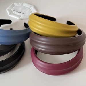 Close-up of padded PU leather headbands in multiple colors with premium grainy texture