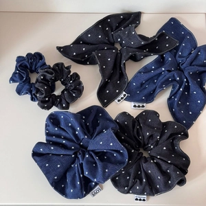 Detail of denim hair scrunchies with white heart patterns and stitched labels